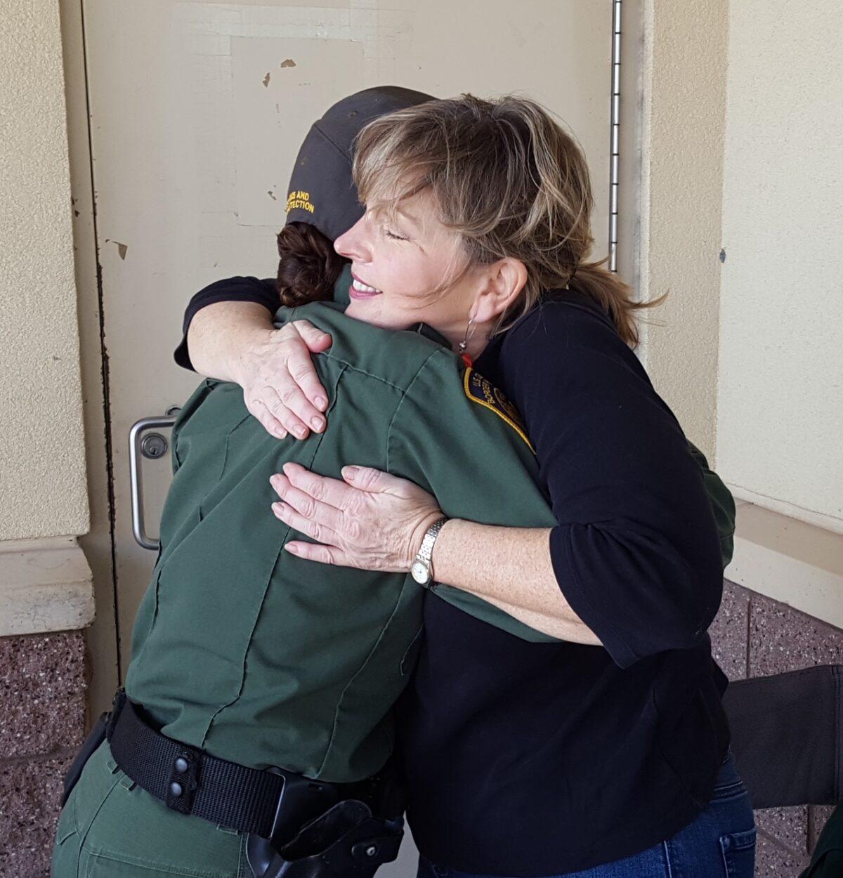 Diane Langan hugs a border patrol agent. (Courtesy of Morale Boosters)