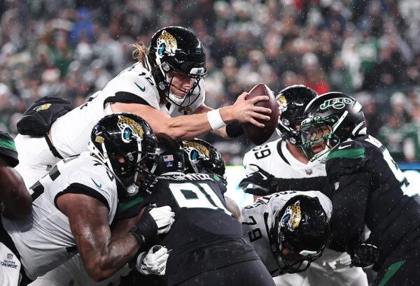 Trevor Lawrence (16) of the Jacksonville Jaguars dives over the goal line for a touchdown during the 1st half of the game against the New York Jets at MetLife Stadium in East Rutherford, N.J. on Dec. 22, 2022. (Dustin Satloff/Getty Images)