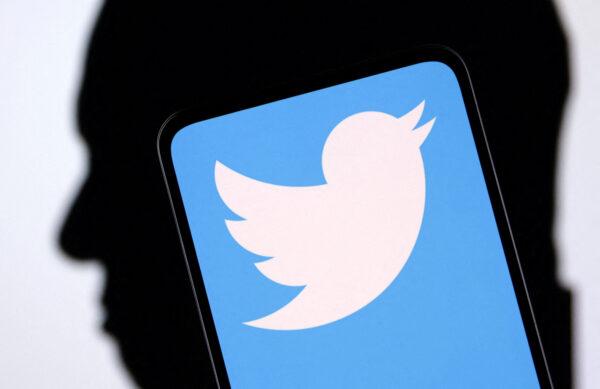 Twitter logo and Elon Musk silhouette in an illustration taken on Dec. 19, 2022. (Dado Ruvic/Illustration/Reuters)