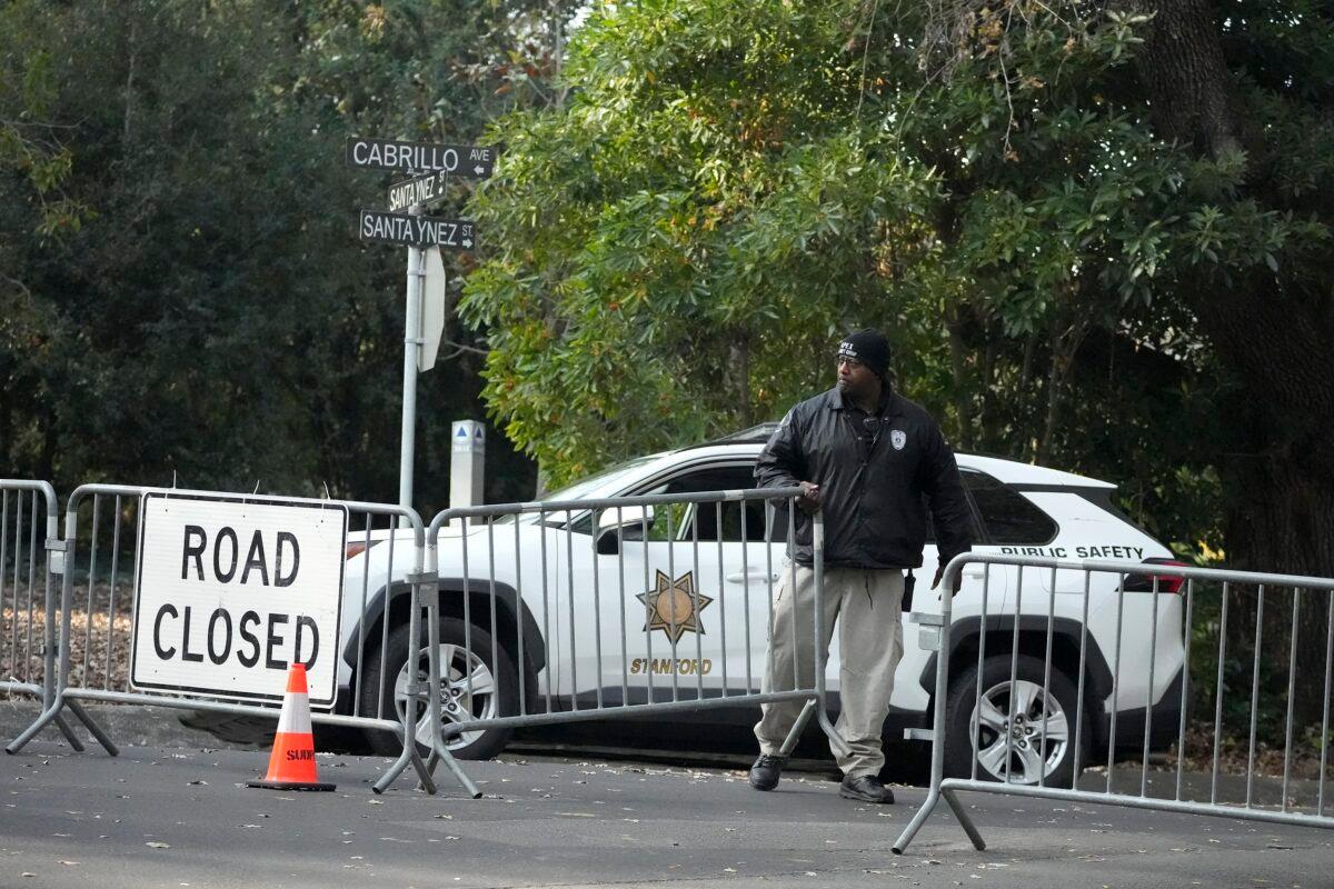 A guard closes barricades to a street near the family home of FTX founder Sam Bankman-Fried in Palo Alto, Calif., on Dec. 23, 2022. (Jeff Chiu/AP Photo)