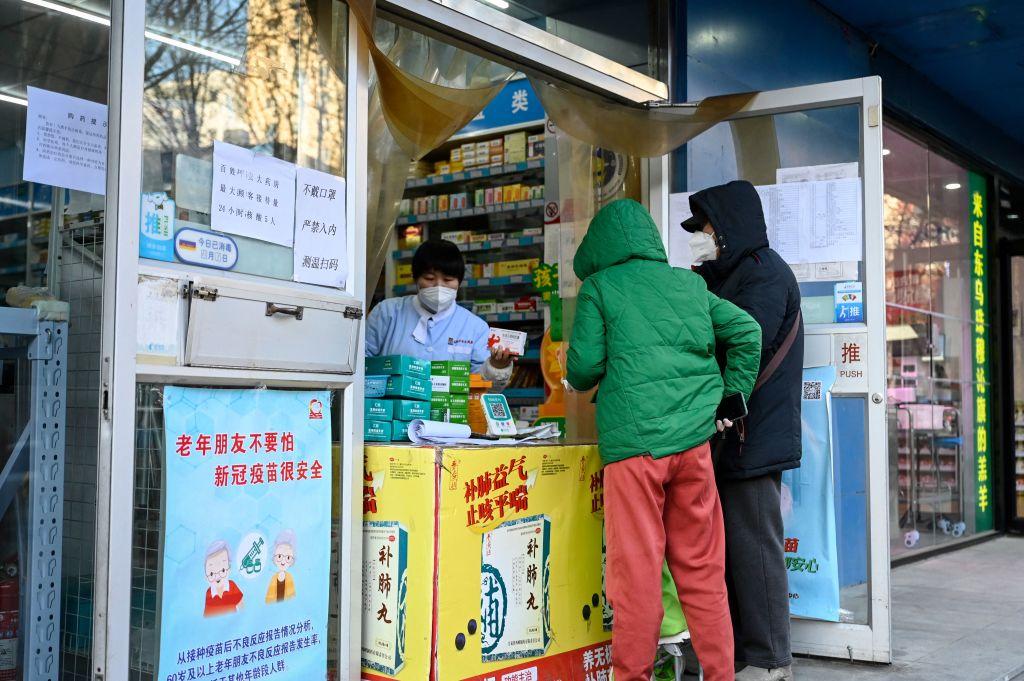 People buy medicines outside a pharmacy amid the Covid-19 pandemic in Beijing on December 17, 2022. (JADE GAO/AFP via Getty Images)