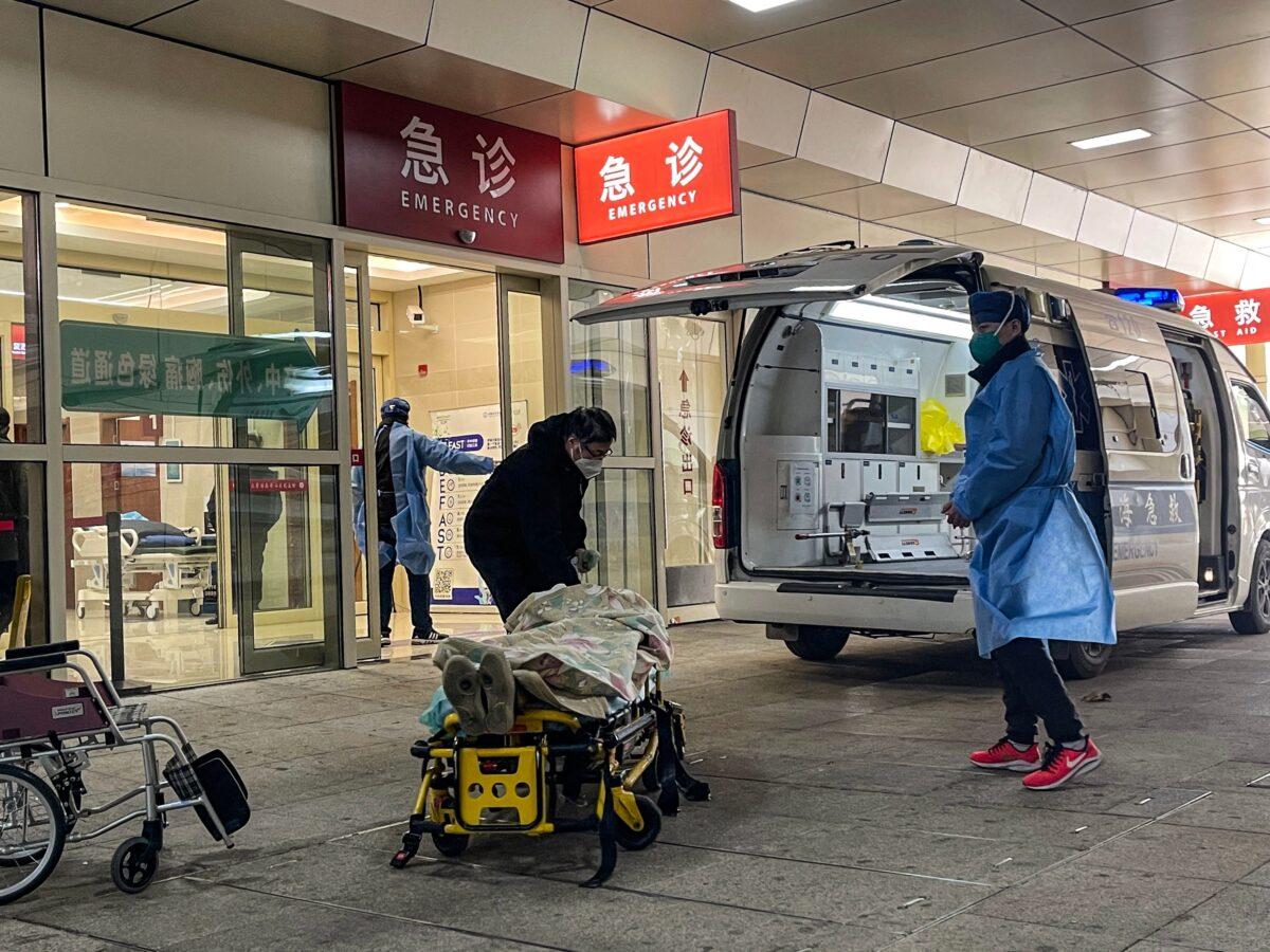 A patient on a stretcher arrives at the emergency area in Huashan Hospital in the Jing'an district in Shanghai, on December 23, 2022. (Hector Retamal/AFP via Getty Images)