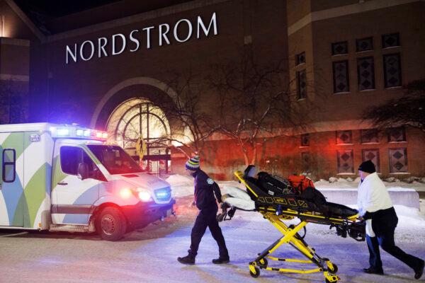 Two first responders and an ambulance are seen after reports of shots fired at the Mall of America in Bloomington, Minn., on Dec. 23, 2022. (Kerem Yücel/Minnesota Public Radio via AP)
