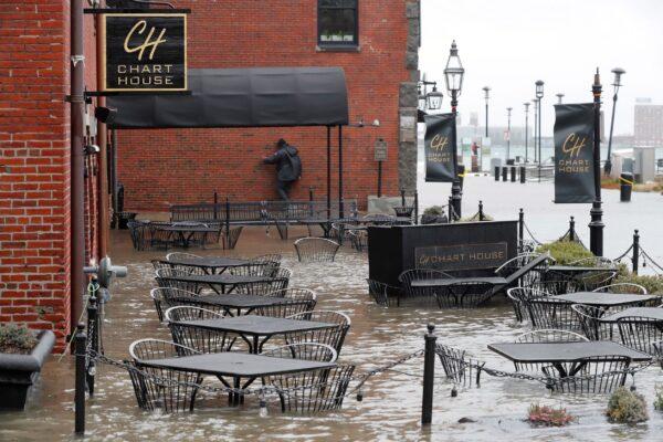 Water floods a restaurant terrace during high tide on Long Wharf, in Boston on Dec. 23, 2022. (Michael Dwyer/AP Photo)