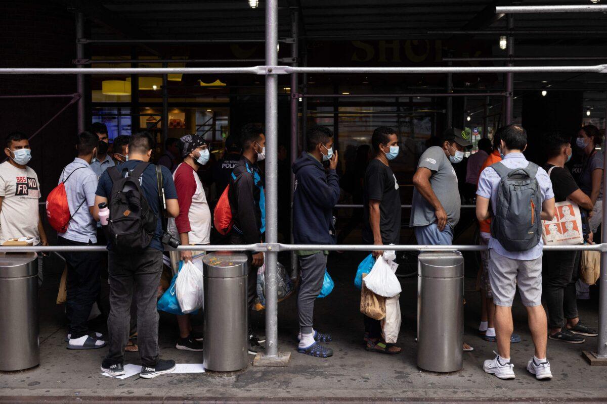A group of migrants from Texas waits in line outside Port Authority Bus Terminal to receive humanitarian assistance in New York on Aug. 10, 2022. (Yuki Iwamura/AFP via Getty Images)