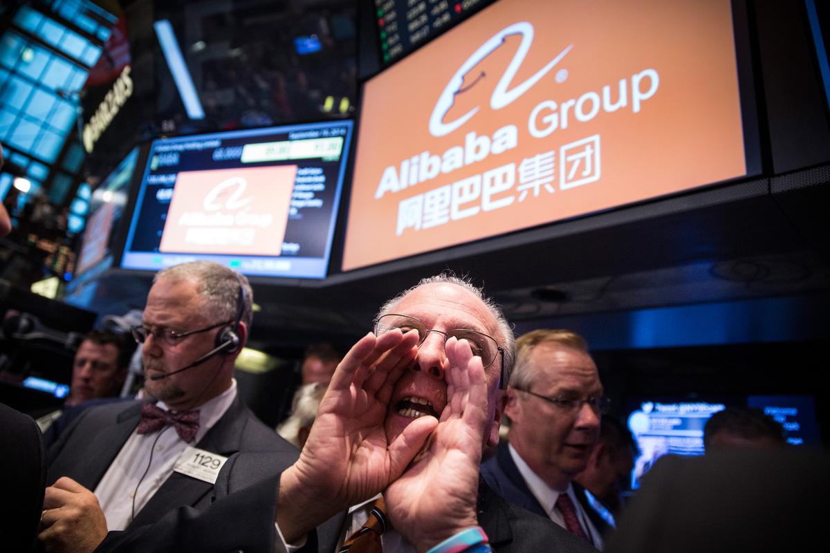 Traders work on the floor of the New York Stock Exchange while the price of Alibaba Group's initial price offering (IPO) is decided, in New York City, on Sept. 19, 2014. (Andrew Burton/Getty Images)