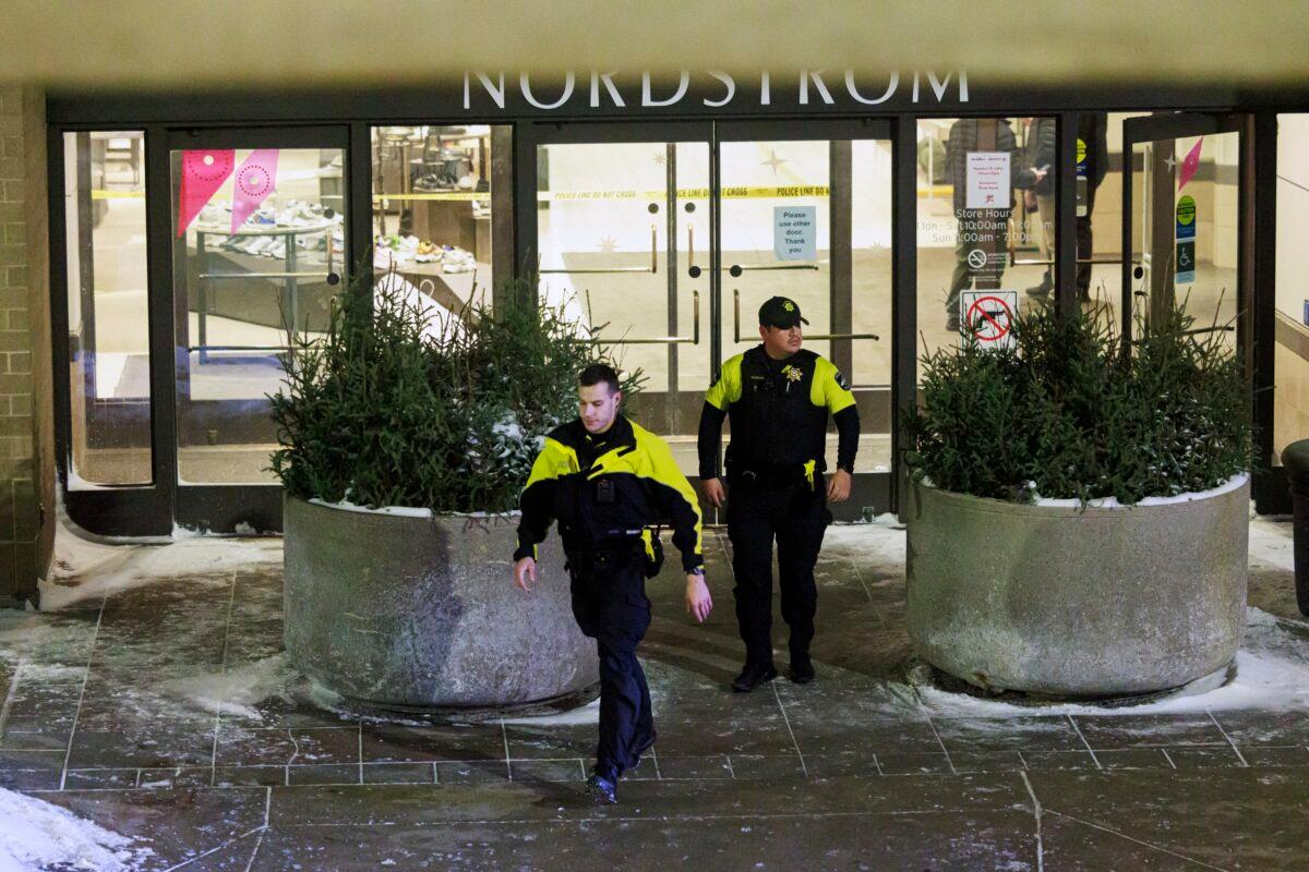 Two officers walk out of Nordstrom in Mall of America in Bloomington, Minn., on Dec. 23, 2022. (Kerem Yücel/Minnesota Public Radio via AP)