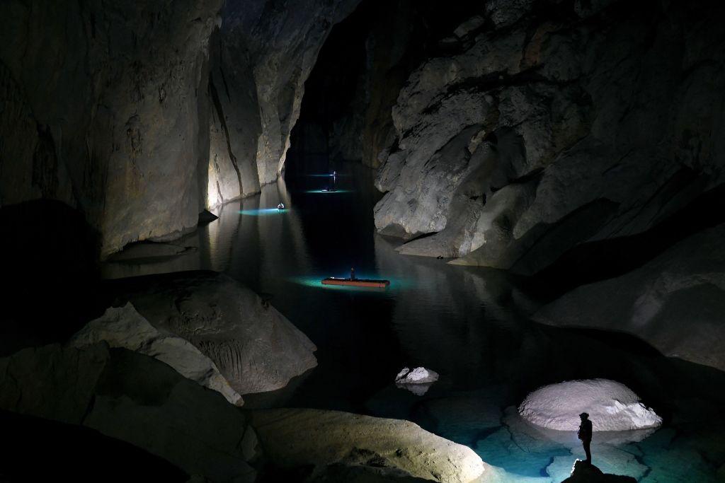 Visitors explore an underground lake in Son Doong cave. (Nhac Nguyen/AFP via Getty Images)