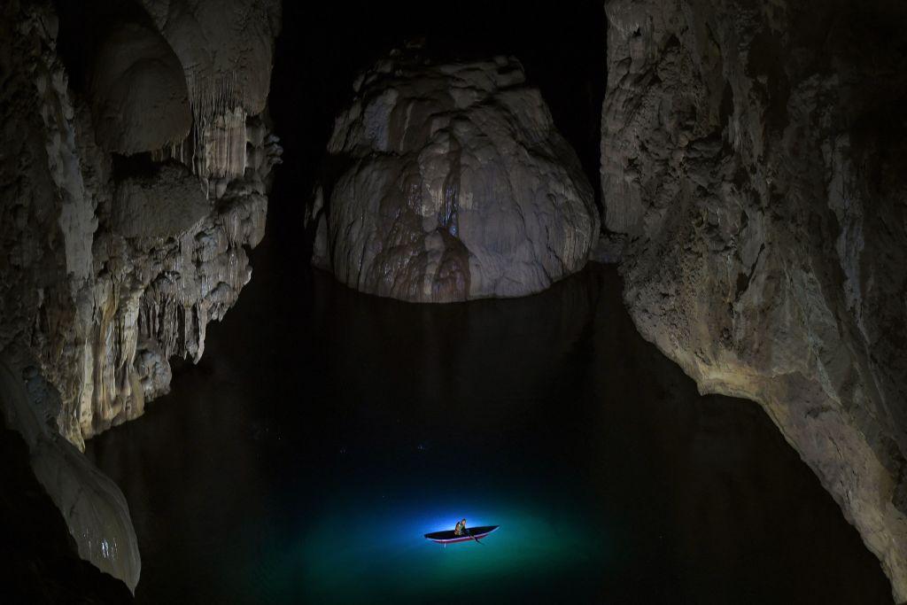 A visitor explores an underground lake in Son Doong cave. (Nhac Nguyen/AFP via Getty Images)