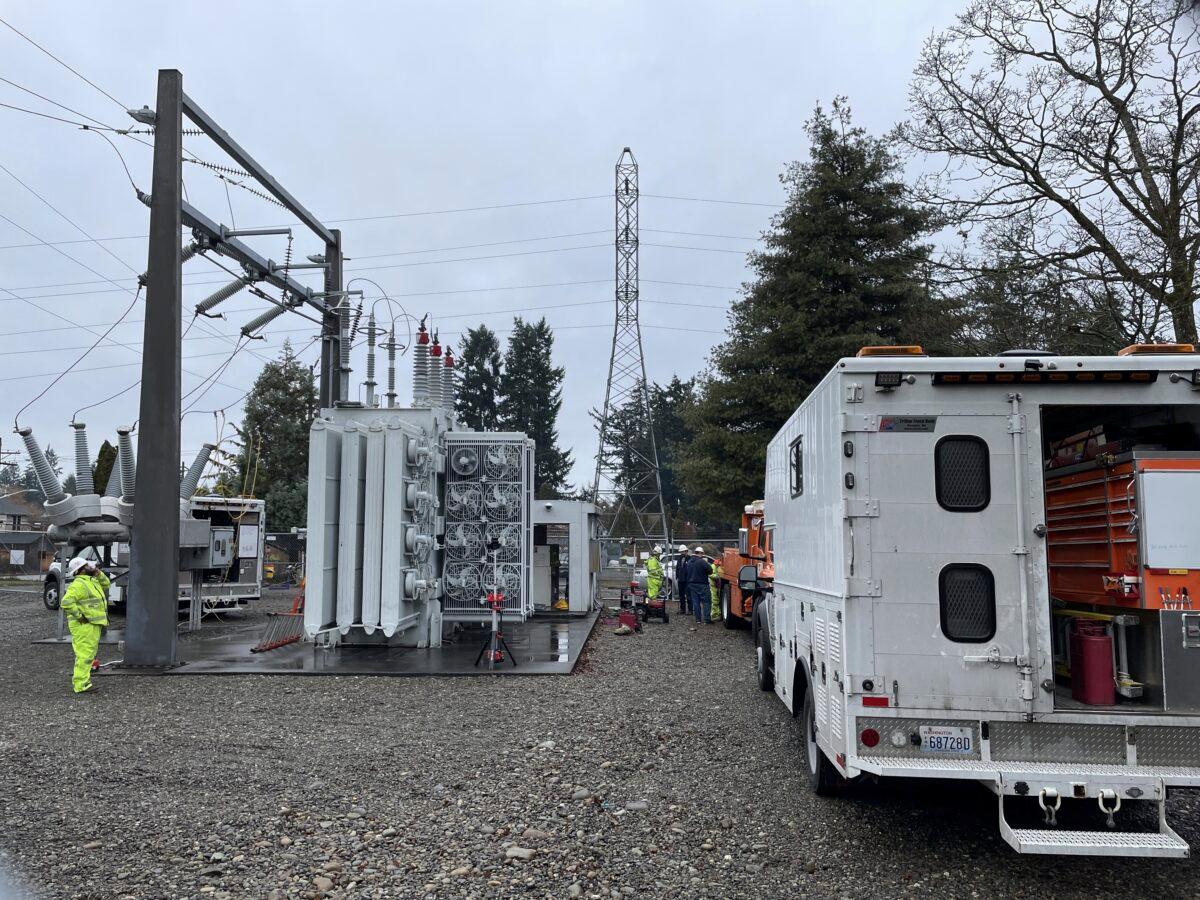 A Tacoma Power crew works at an electrical substation damaged by vandals in Graham, Wash., on Dec. 25, 2022. (Ken Lambert/The Seattle Times via AP)