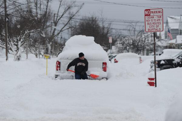 A man tries to dig his truck out of deep snow in Buffalo, N.Y. on Dec. 26, 2022. (John Normile/Getty Images)