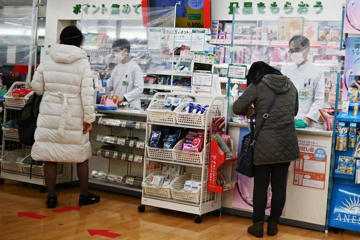 Drugstore employees help customers in Tokyo on April 13, 2020. Japanese pharmacies are seeing shortages as Chinese buyers stock up on medicines to send back to family members in China. (Harly Triballeau/AFP via Getty Images)