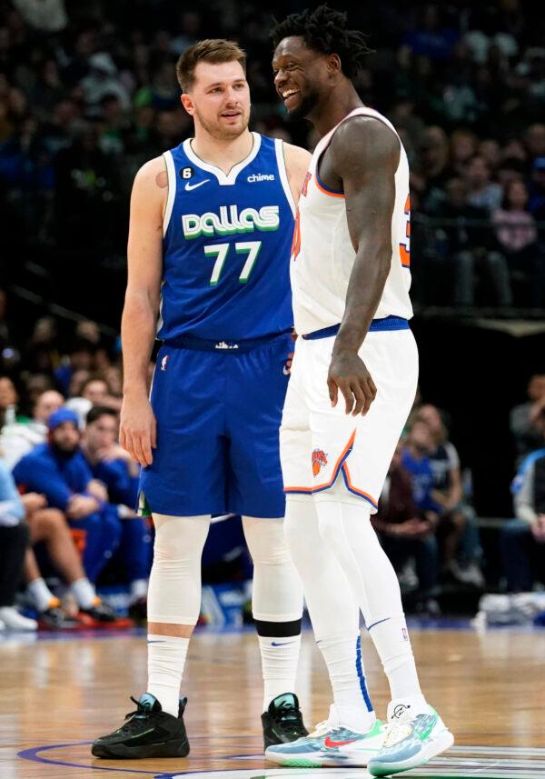 New York Knicks forward Julius Randle (30) and Dallas Mavericks guard Luka Doncic (77) laugh while standing at half-court during the first half of an NBA basketball game in Dallas on Dec. 27, 2022. (LM Otero/AP Photo)