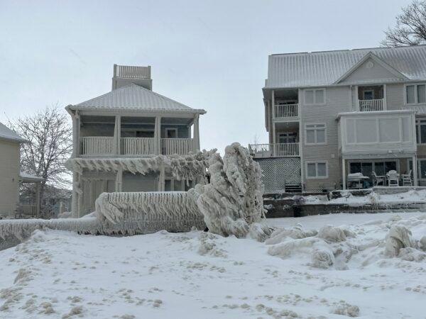 Houses along the shore of Crystal Beach in Fort Erie, Ont., are completely engulfed in ice after a winter storm on Dec. 25, 2022. (Courtesy of Tracey Cotton)