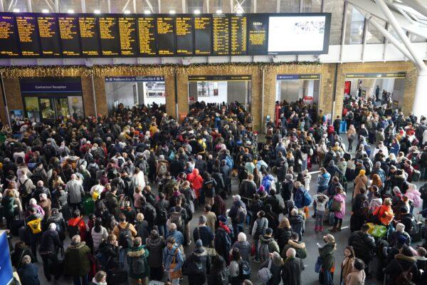 Passengers wait at the barriers at King's Cross station following a strike by members of the Rail, Maritime, and Transport union (RMT), in a long-running dispute over jobs and pensions, in London, on Dec. 27, 2022. (James Manning/PA Media)