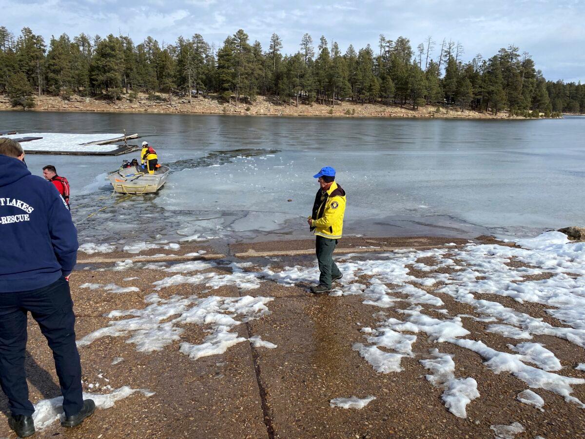 A search team works to recover two of three people who drowned after they fell through the ice at Woods Canyon Lake in Forest Lakes, Ariz., on Dec. 27, 2022. (Jon Paxton/Coconino County Sheriff's Office via AP)