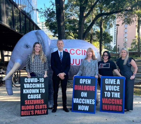 Vaccine-choice activist Justin Harvey (2L) stands with women who say they were injured by the COVID-19 vaccine outside a meeting of the Orange County Board of County Commissioners meeting in Orlando, Fla. on Nov. 29, 2022. (Courtesy of Justin Harvey)