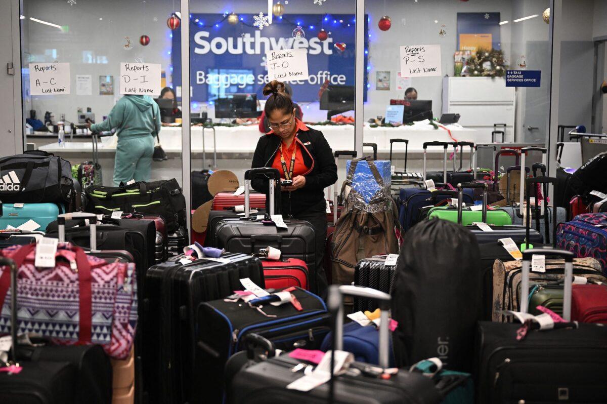 A Southwest Airlines ground crew member organizes unclaimed luggage at the Southwest Airlines luggage area, at Los Angeles International Airport in California, on Dec. 28, 2022. (Robyn Beck/AFP/Getty Images)