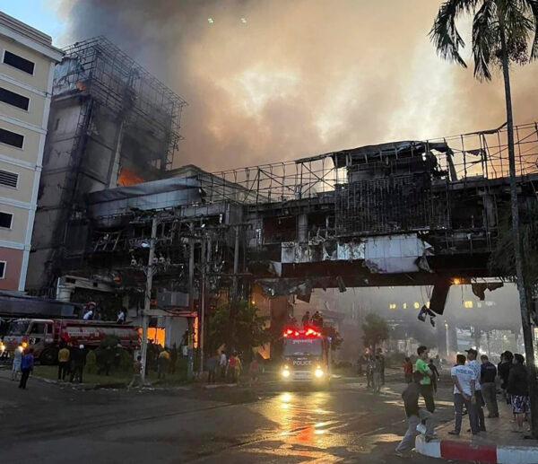 Smoke rises as a fire burn through a Cambodian hotel-casino near a Cambodia-Thai international border gate in Poipet, west of Phnom Penh, Cambodia, on Dec. 28, 2022. (Fresh News/Photo via AP)