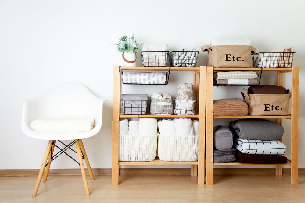 Baskets add texture and warmth to a closet, cubed storage units, or shelves because they organize everything from sweaters to craft supplies. (Kostikova Natalia/Shutterstock)
