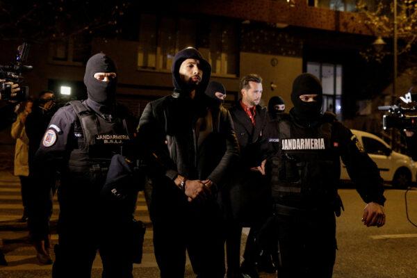 Andrew Tate and Tristan Tate are escorted by police officers outside the headquarters of the Directorate for Investigating Organized Crime and Terrorism in Bucharest (DIICOT) after being detained for 24 hours, in Bucharest, Romania, December 29, 2022. Inquam Photos/Octav Ganea via REUTERS