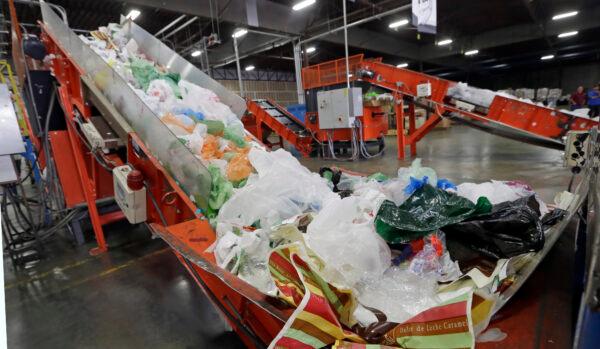 Conveyors carry mixed plastic into a device that will shred and recycle them at a plastics recycling plant in Vernon, Calif., on Jan. 24, 2014. (Reed Saxon/AP Photo)