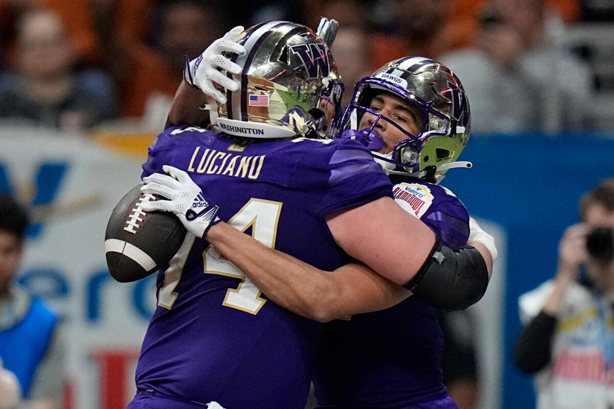 Washington wide receiver Jalen McMillan (L) celebrates with teammate Corey Luciano (74) after scoring a touchdown against Texas during the second half of the Alamo Bowl NCAA college football game in San Antonio on Dec. 29, 2022. (Eric Gay/AP Photo)