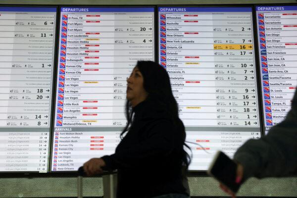 The departures board is overwhelmed with delayed and canceled flights at Dallas Love Field in a file photo. (Shelby Tauber/Reuters)