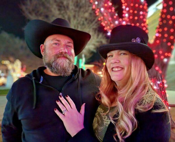 Gavin and Amber Cerio of Glendale, Ariz., say the key is to stay positive in 2023, during the annual New Year's Eve Boot Drop in Prescott, Ariz., on Dec. 31, 2022. (Allan Stein/The Epoch Times)