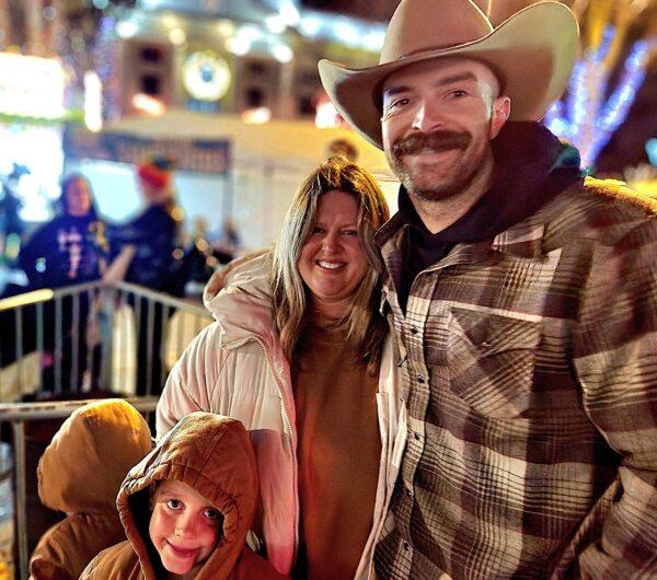 Jonathan St. Burgh and his family in Prescott, Ariz., on Dec. 31, 2022. They drove from California to be with family and attend the New Year's Eve Boot Drop, and St. Burgh said he resolves to do his best in his new job as a Los Angeles Police K9 officer in 2023. (Allan Stein/The Epoch Times)