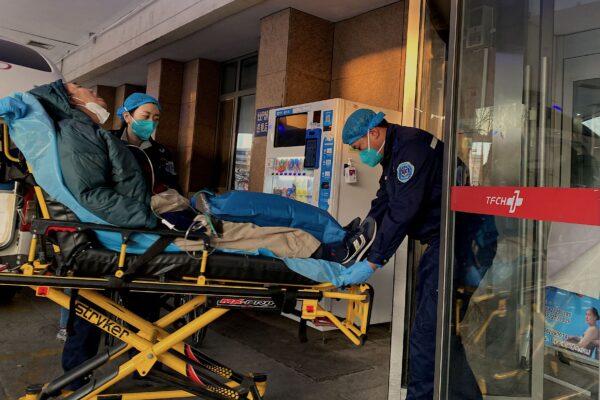 Health workers move a COVID-19 patient at Tianjin First Center Hospital in Tianjin, China, on Dec. 28, 2022. (Noel Cells/AFP via Getty Images)