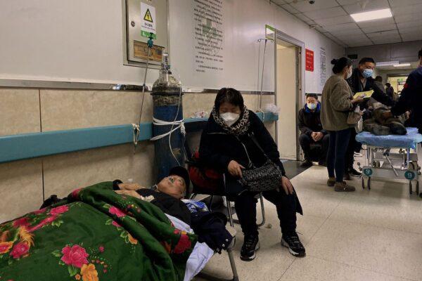 A patient with COVID-19 lays on a bed in a hallway at Tangshan Gongren Hospital in China's northeastern city of Tangshan on Dec. 30, 2022. (Noel Celis/AFP via Getty Images)