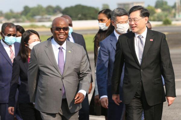 China's Minister of Foreign Affairs Qin Gang (R) is greeted by his Gabon counterpart Michael Moussa Adamo (3L) upon his arrival at the Leon Mba International Airport in Libreville, Gabon, on Jan. 11, 2023. (Steeve Jordan/AFP via Getty Images)