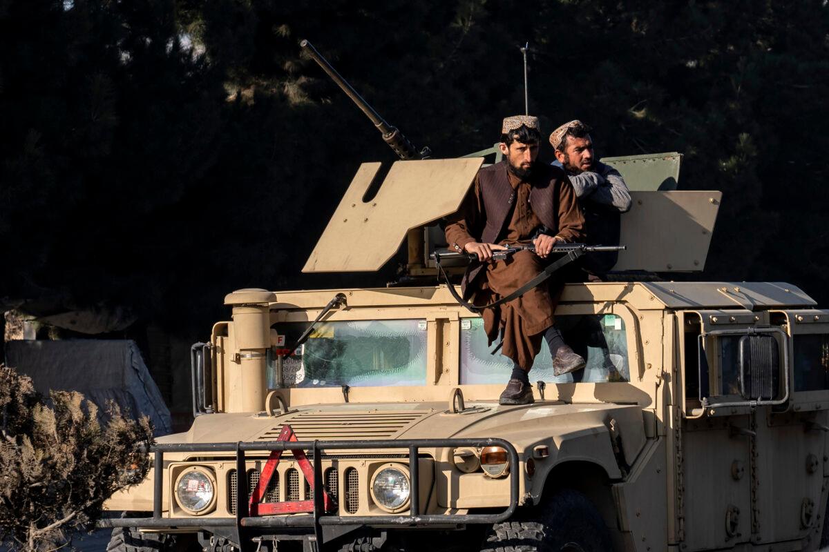 Taliban terrorists stand guard at the site of an explosion near the Interior Ministry, in Kabul, Afghanistan, on Jan. 1, 2023. (Ebrahim Noroozi/AP Photo)