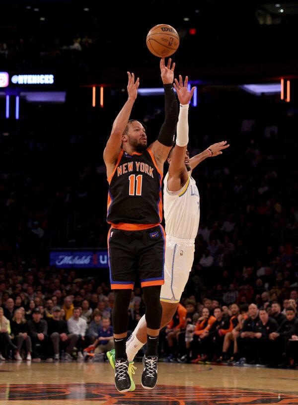 Jalen Brunson (11) of the New York Knicks shoots a three point shot at the buzzer in the first quarter as Troy Brown Jr. (7) of the Los Angeles Lakers defends at Madison Square Garden in New York City on Jan. 31, 2023.(Elsa/Getty Images)