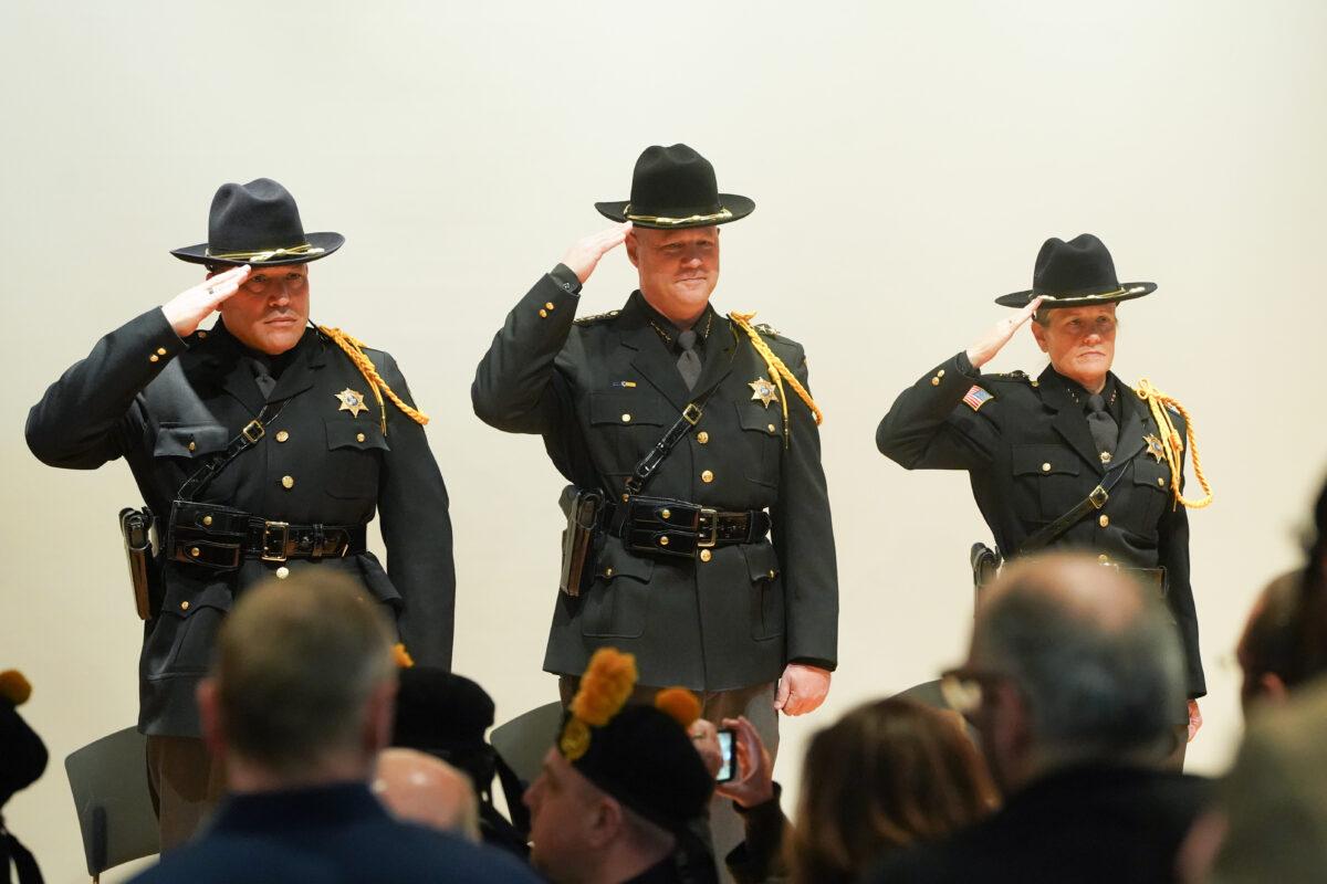 Wilfredo Garcia (L), Paul Arteta (C) and Evelyn Mallard (R) at their inauguration ceremony for the county's sheriff's office at the emergency services center in Orange County, N.Y., on Jan 1, 2023. (Cara Ding/The Epoch Times)