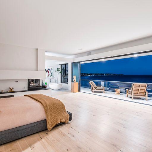 With the glass wall fully retracted, the view from the top-level master suite is a panoramic delight. (The Luxury Level, Toptenrealestatedeals.com)
