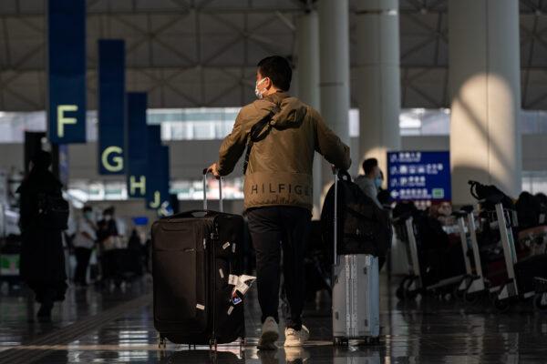 Travelers walk at the departure hall of the Hong Kong International Airport in Hong Kong, on Dec. 30, 2022. (Anthony Kwan/Getty Images)
