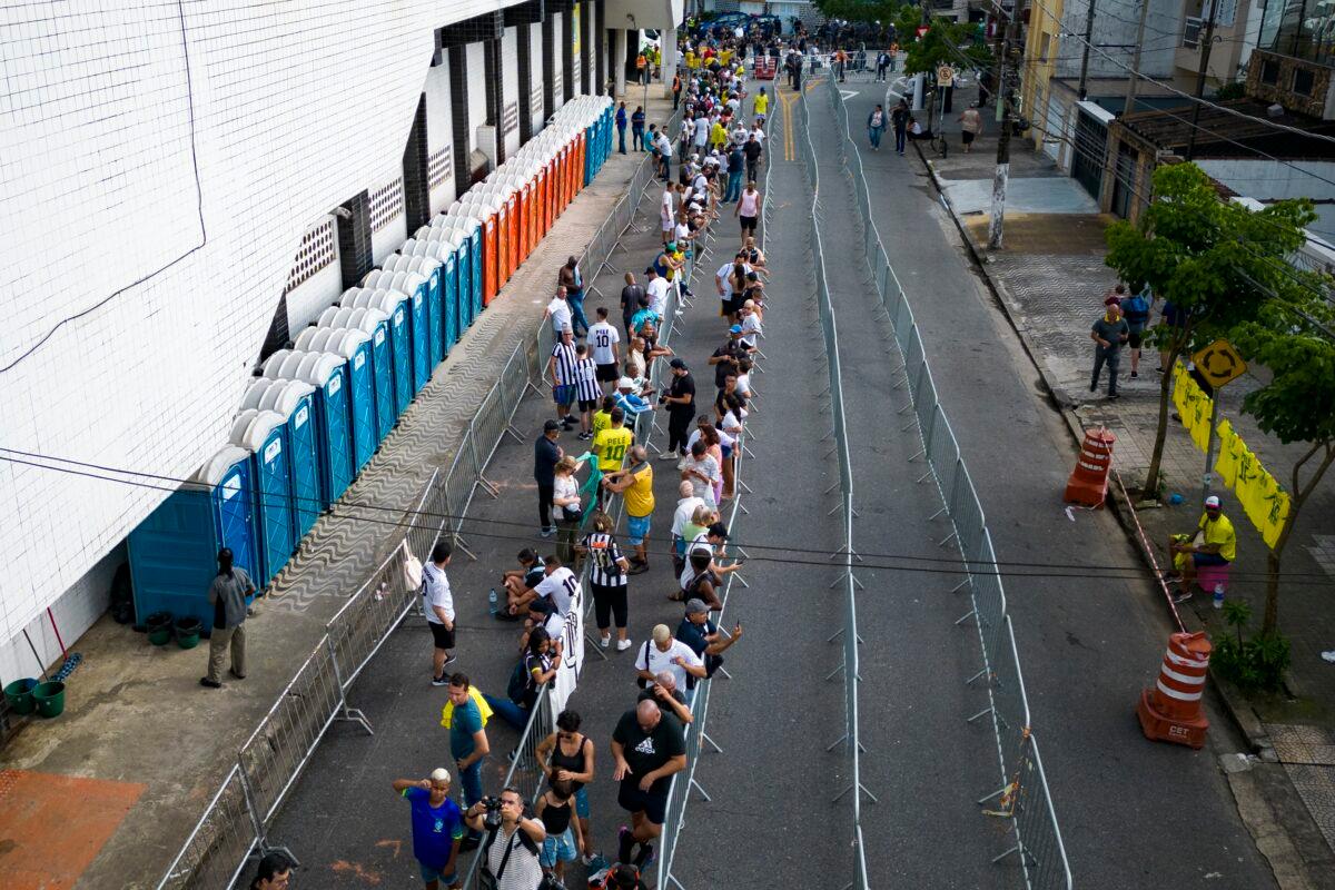 Soccer fans line up to attend the funeral of the late Brazilian soccer legend Pele at the Vila Belmiro stadium in Santos, Brazil, on Jan. 2, 2023. (Matias Delacroix/AP Photo)