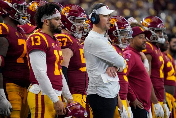 Southern California quarterback Caleb Williams (13) and head coach Lincoln Riley watch play during the first half of the Cotton Bowl NCAA college football game against Tulane, in Arlington, Texas, Jan. 2, 2023. (Sam Hodde/AP Photo)