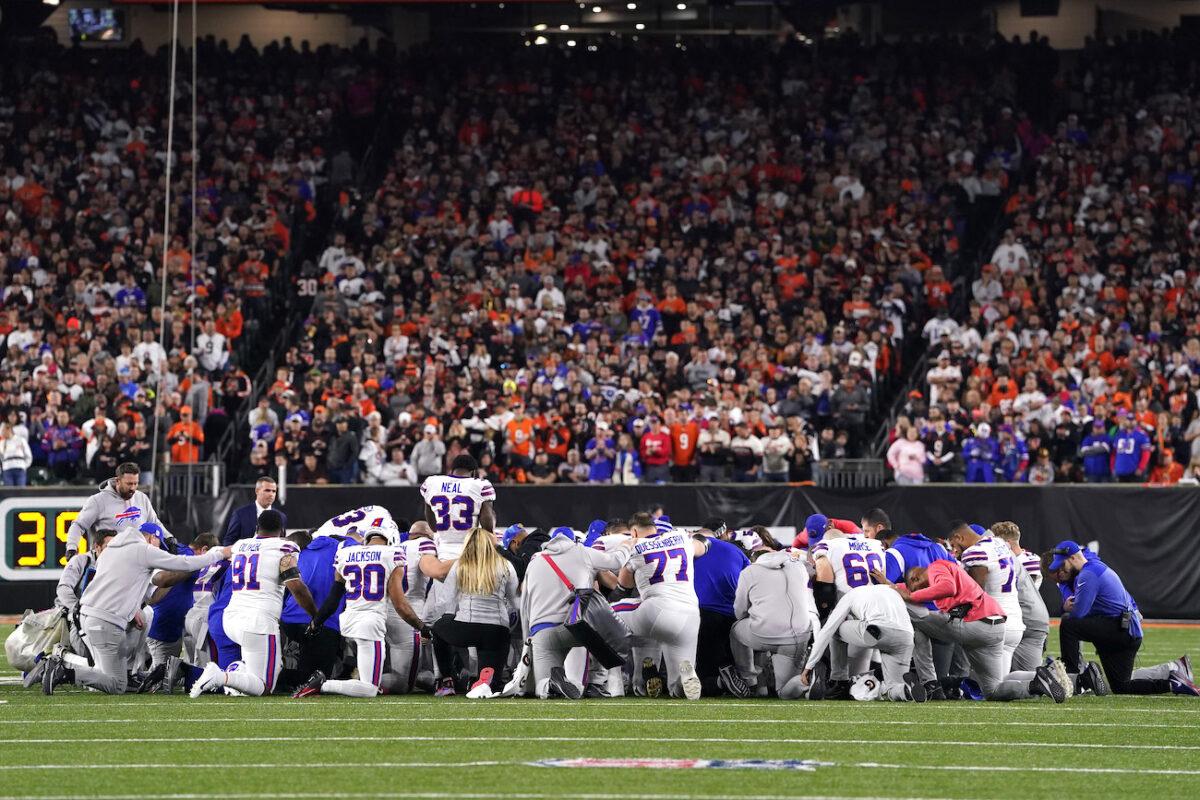 Buffalo Bills players huddle in prayer after teammate Damar Hamlin #3 collapsed on the field after making a tackle against the Cincinnati Bengals during the first quarter at Paycor Stadium in Cincinnati, Ohio, on Jan. 2, 2023. (Dylan Buell/Getty Images)
