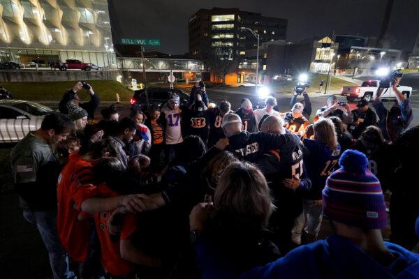 Fans gather for a vigil at the University of Cincinnati Medical Center for football player Damar Hamlin of the Buffalo Bills, who collapsed after making a tackle during the game against the Cincinnati Bengals and was transported by ambulance to the hospital in Cincinnati, Ohio, on Jan. 2, 2023. (Dylan Buell/Getty Images)