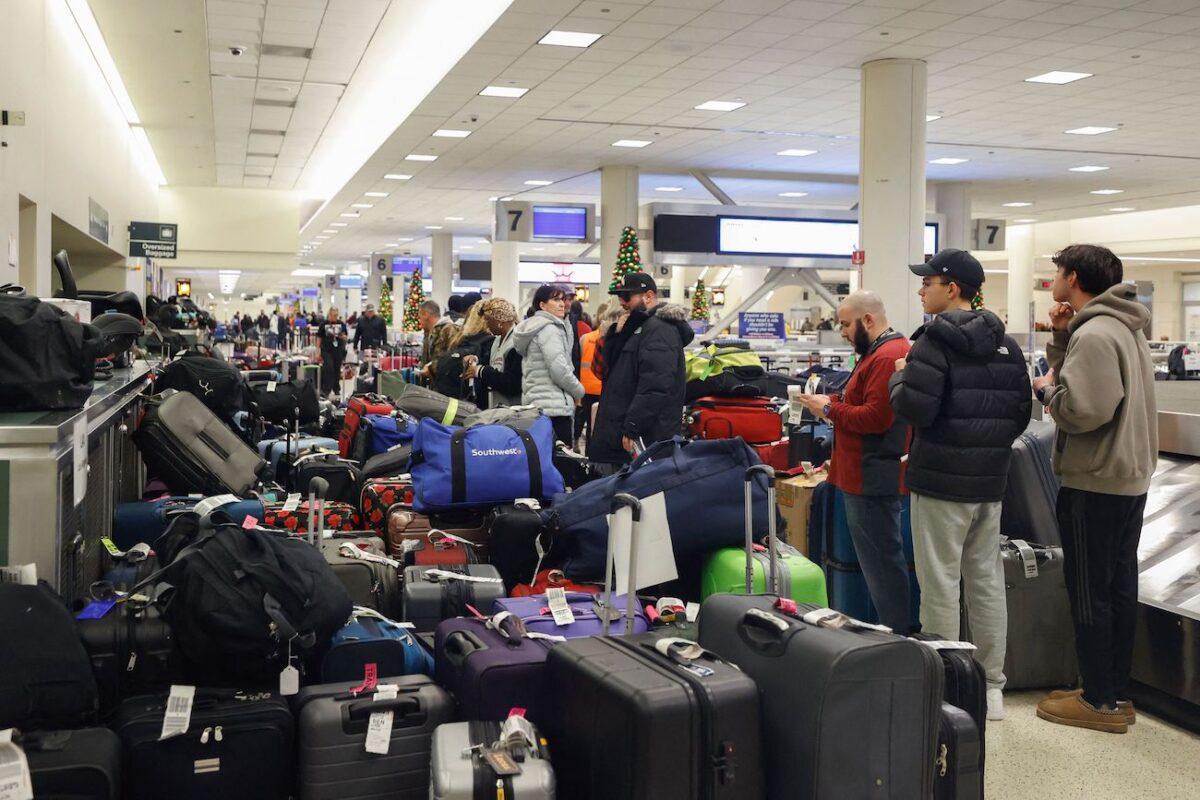 Stranded Southwest Airlines passengers look for their luggage in the baggage claim area at Chicago Midway International Airport in Chicago on Dec. 28, 2022. (Kamil Krzaczynski/AFP via Getty Images)