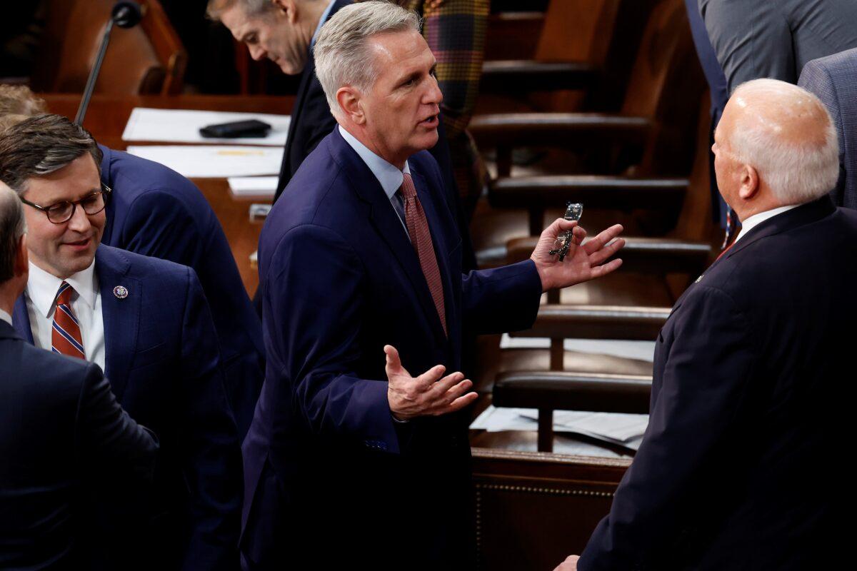 U.S. House Minority Leader Kevin McCarthy (R-CA) (C) talks with members of the House in between roll call votes for Speaker of the House of the 118th Congress in the House Chamber of the U.S. Capitol Building in Washington on Jan. 3, 2023. (Chip Somodevilla/Getty Images)