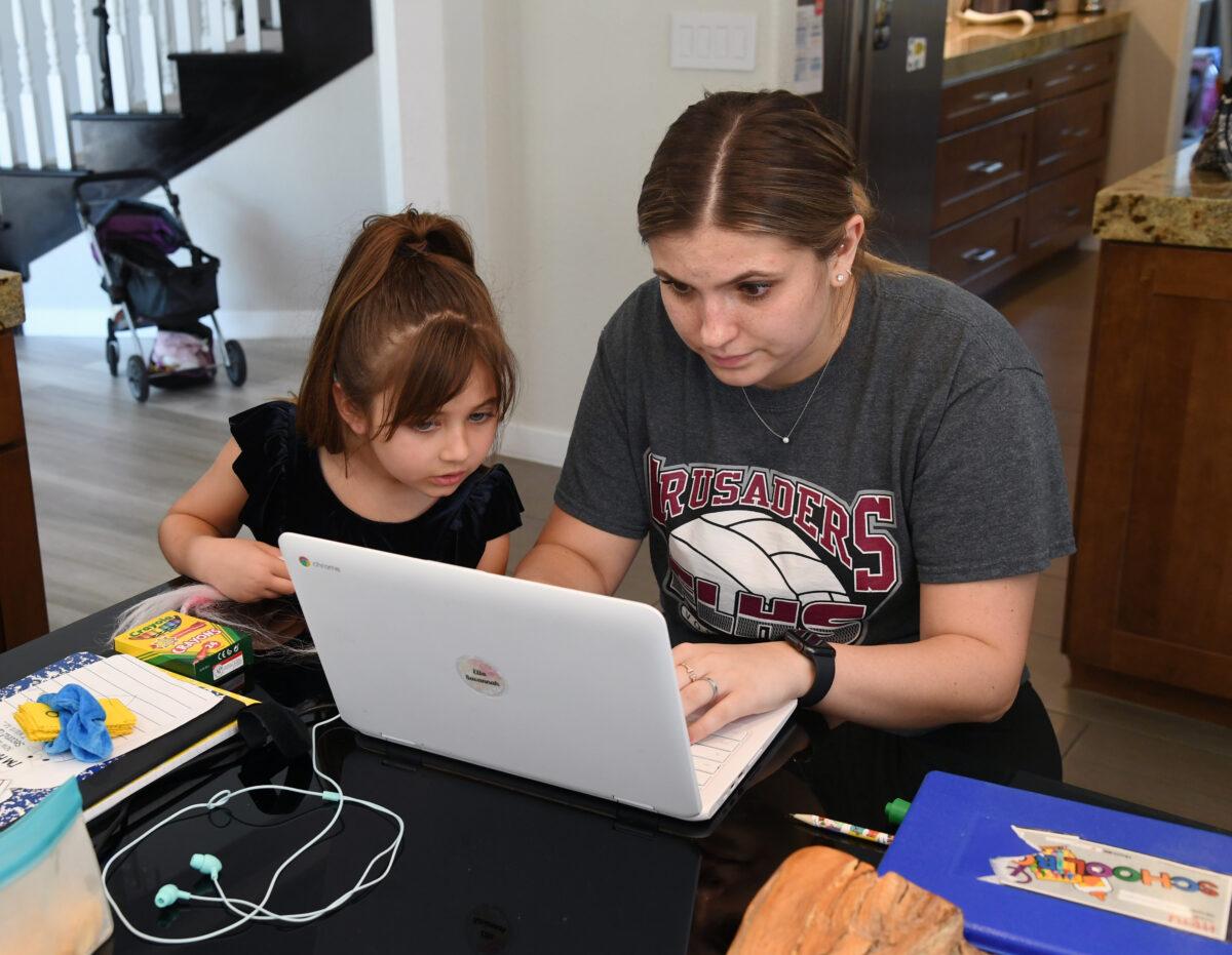 Goolsby Elementary School 2nd grader Ella Dweck (L) is tutored by College of Southern Nevada student Jordyn Leal during the first week of distance learning for the Clark County School District amid the spread of COVID-19 in Las Vegas, Nev., on Aug. 25, 2020. (Ethan Miller/Getty Images)
