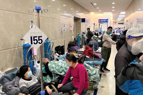 Patients lie on beds in a hallway in the emergency department of Zhongshan Hospital amid a COVID-19 outbreak in Shanghai, China, on Jan. 3, 2023. (Staff/Reuters)
