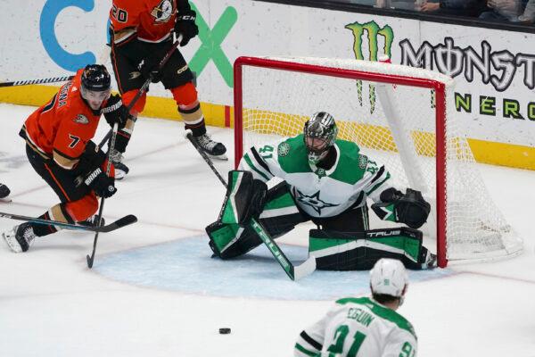 Dallas Stars goaltender Scott Wedgewood (41) and Anaheim Ducks center Jayson Megna (7) watch the puck during the first period of an NHL hockey game in Anaheim, Calif., Jan. 4, 2023. (Allison Dinner/AP Photo)