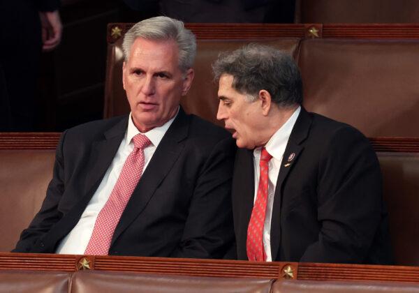 House Republican Leader Kevin McCarthy (R-Calif.) (L) talks to Rep.-elect Andrew Clyde (R-Ga.) in the House chamber during the third day of elections for House Speaker at the U.S. Capitol in Washington on Jan. 5, 2023. (Win McNamee/Getty Images)