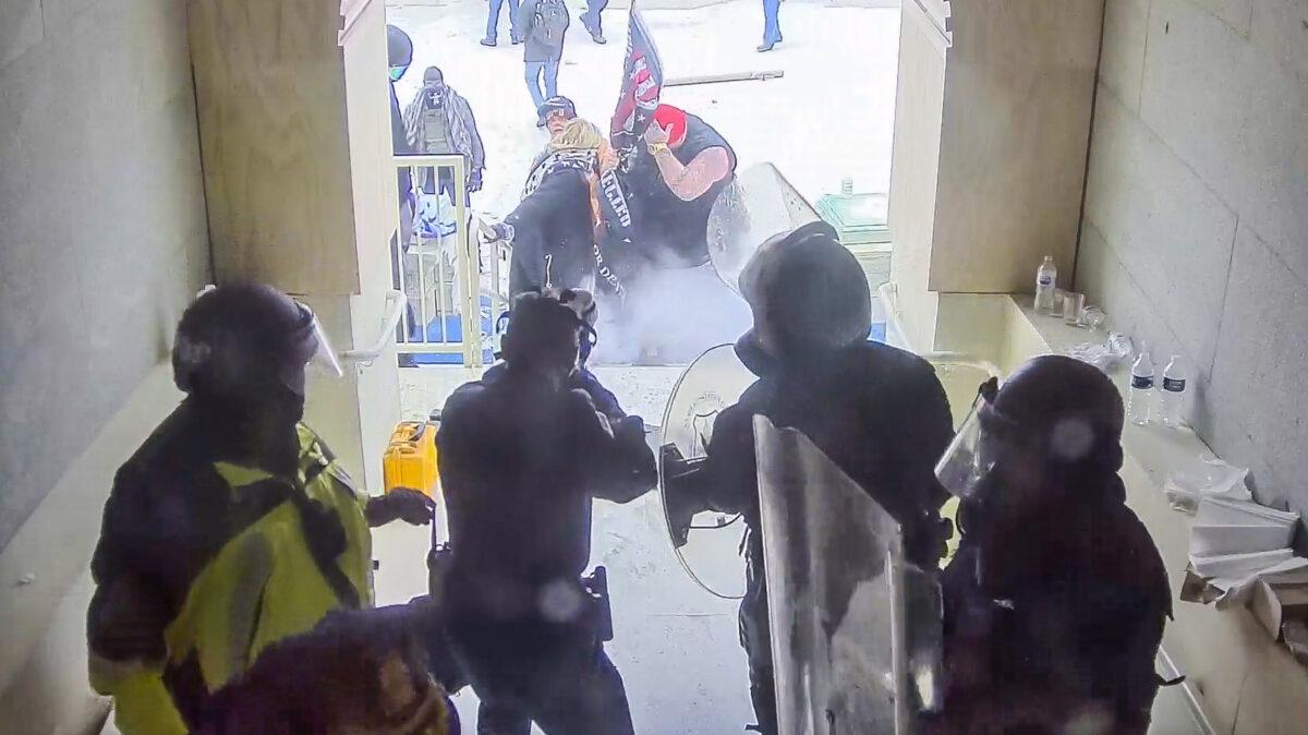 Police fire rubber bullets at the first protesters who try to enter the Lower West Terrace tunnel at the U.S. Capitol on Jan. 6, 2021. (U.S. Capitol Police/Screenshot via The Epoch Times)
