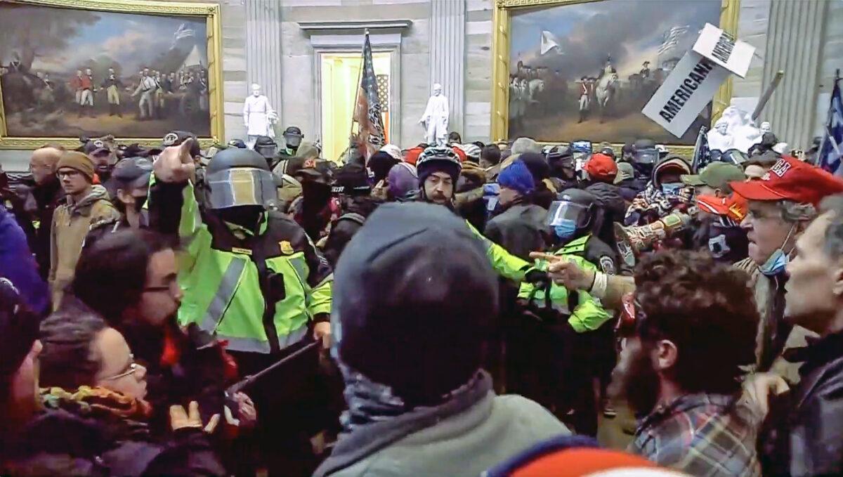 D.C. Metropolitan Police Department officers skirmish with protesters in the Capitol Rotunda in Washington on Jan. 6, 2021. (U.S. Department of Justice/Screenshot via The Epoch Times)